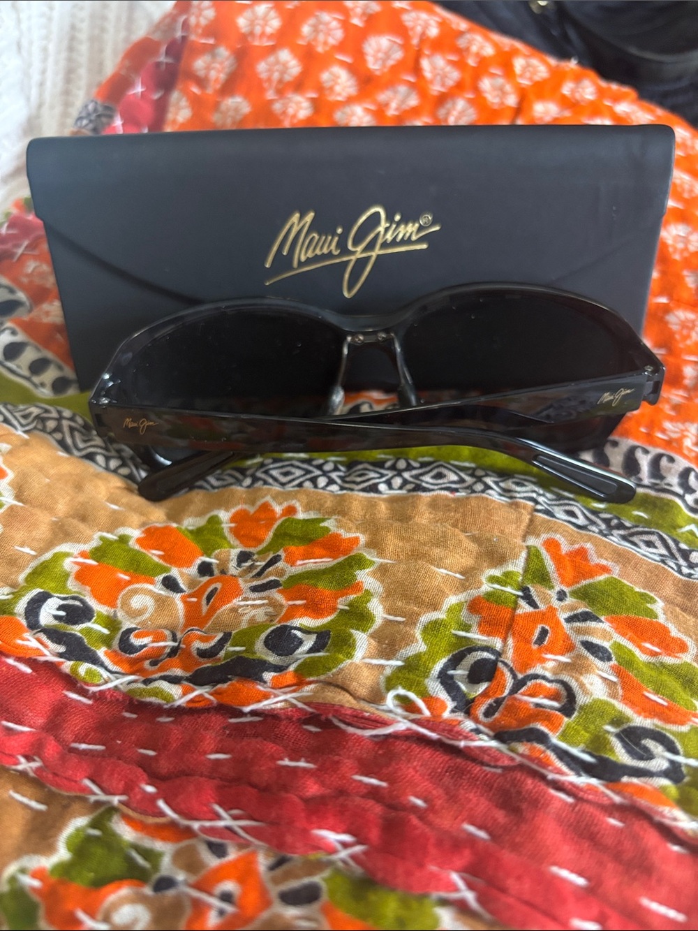 Maui Jim Black Sunglasses with Dark Lenses and Gold Logo Accent